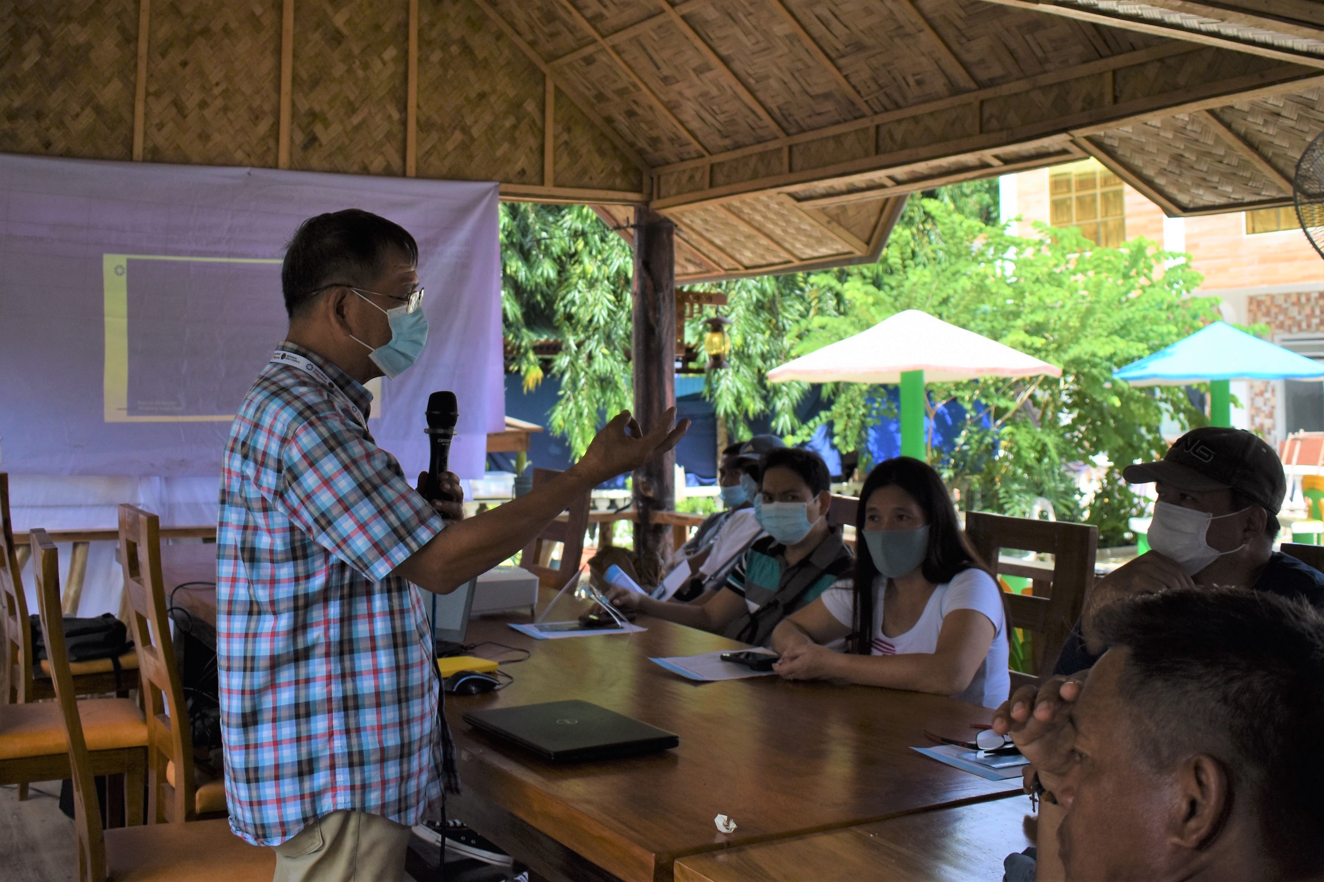 Philippines project presenter with group wearing face masks