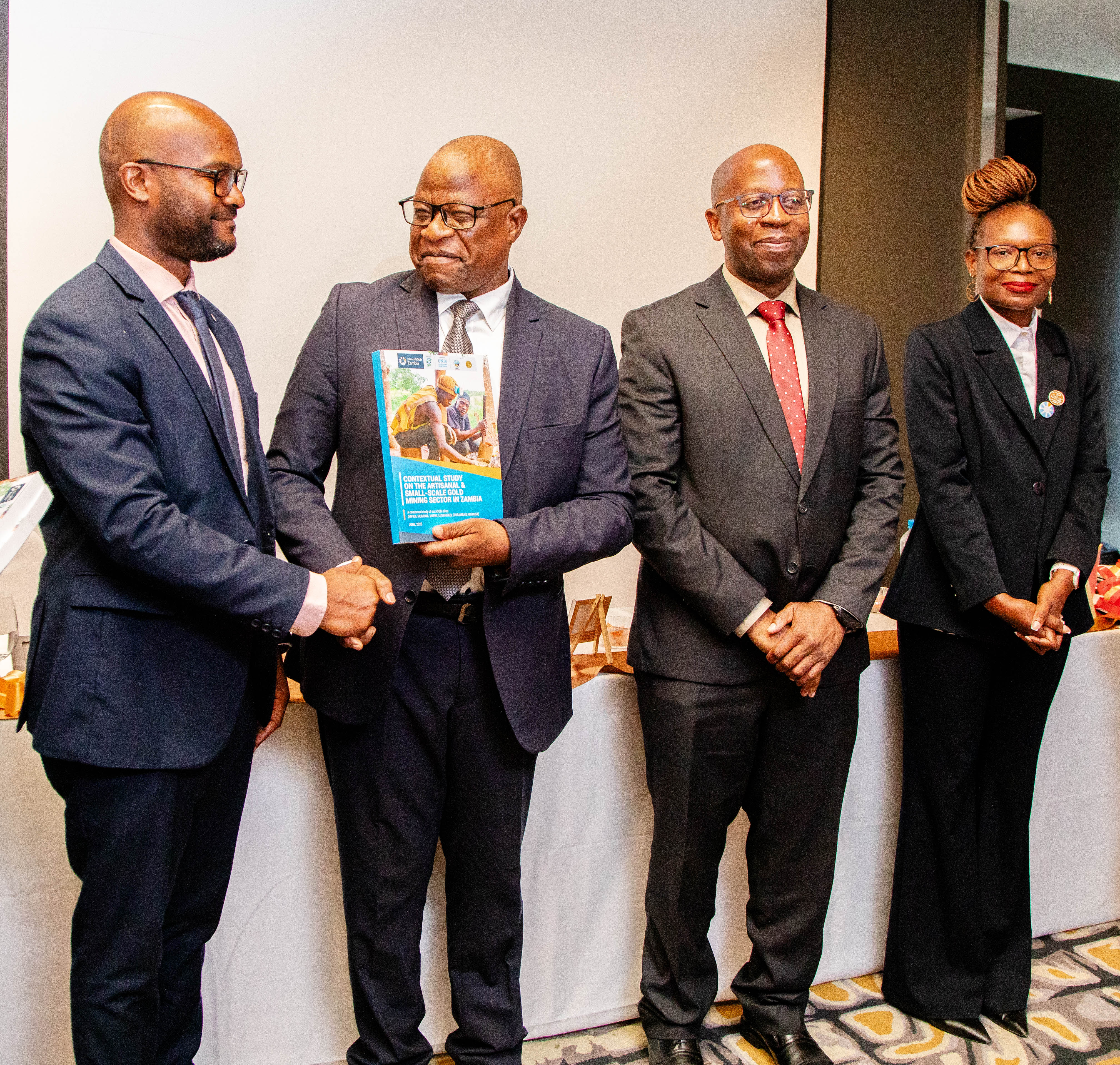 Dr. Hapenga M. Kabeta the Permanent Secretary for the Mininstry of Mines and Minerals Development handing over the Contextual Report to various stakeholders in ASGM Sector 