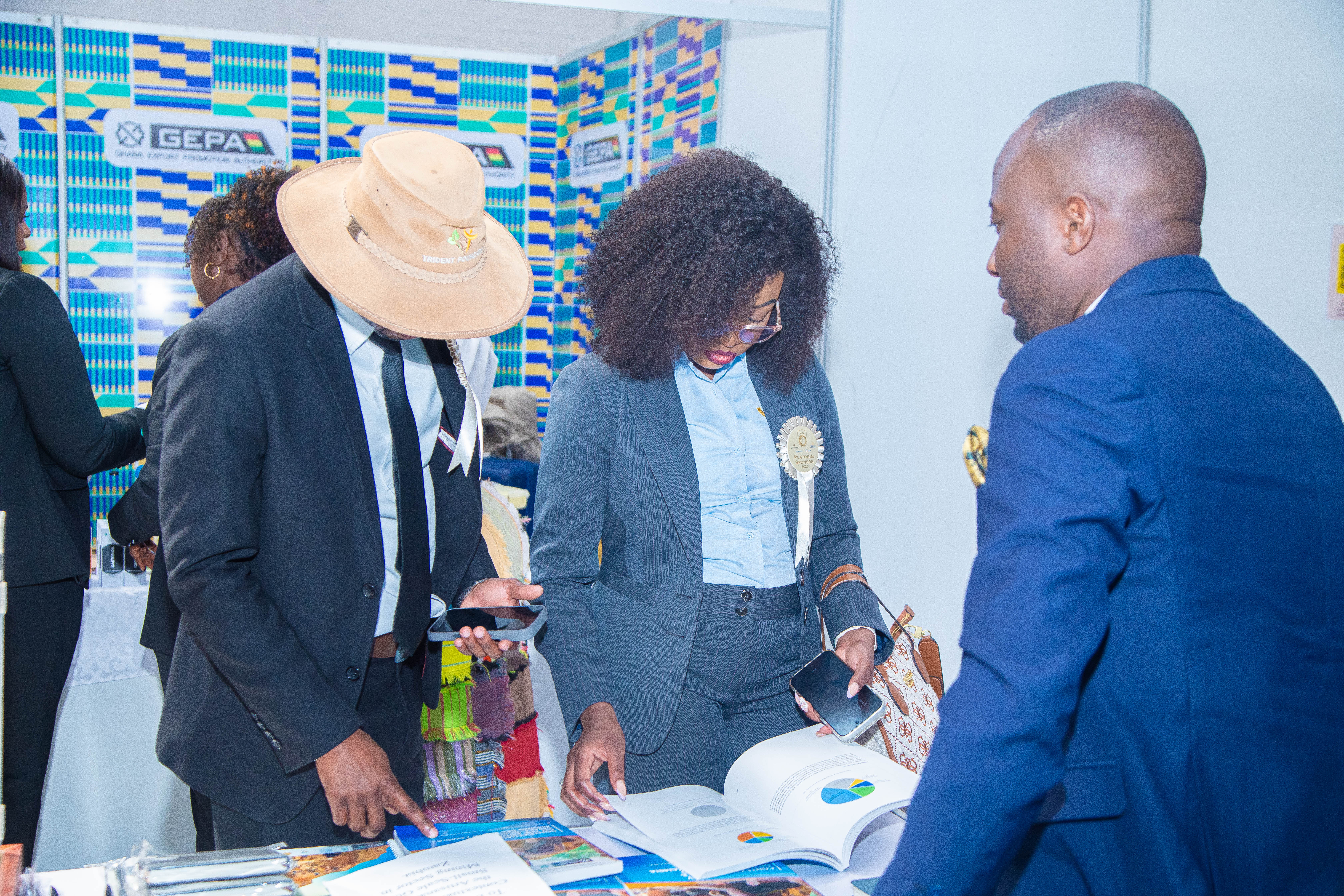 The planetGOLD Zambia Project Communications Officer Mr. Jefferson Kapasa Presenting encouraging show goers to scan and download the Contextual Study Report from the planetGOLD Website