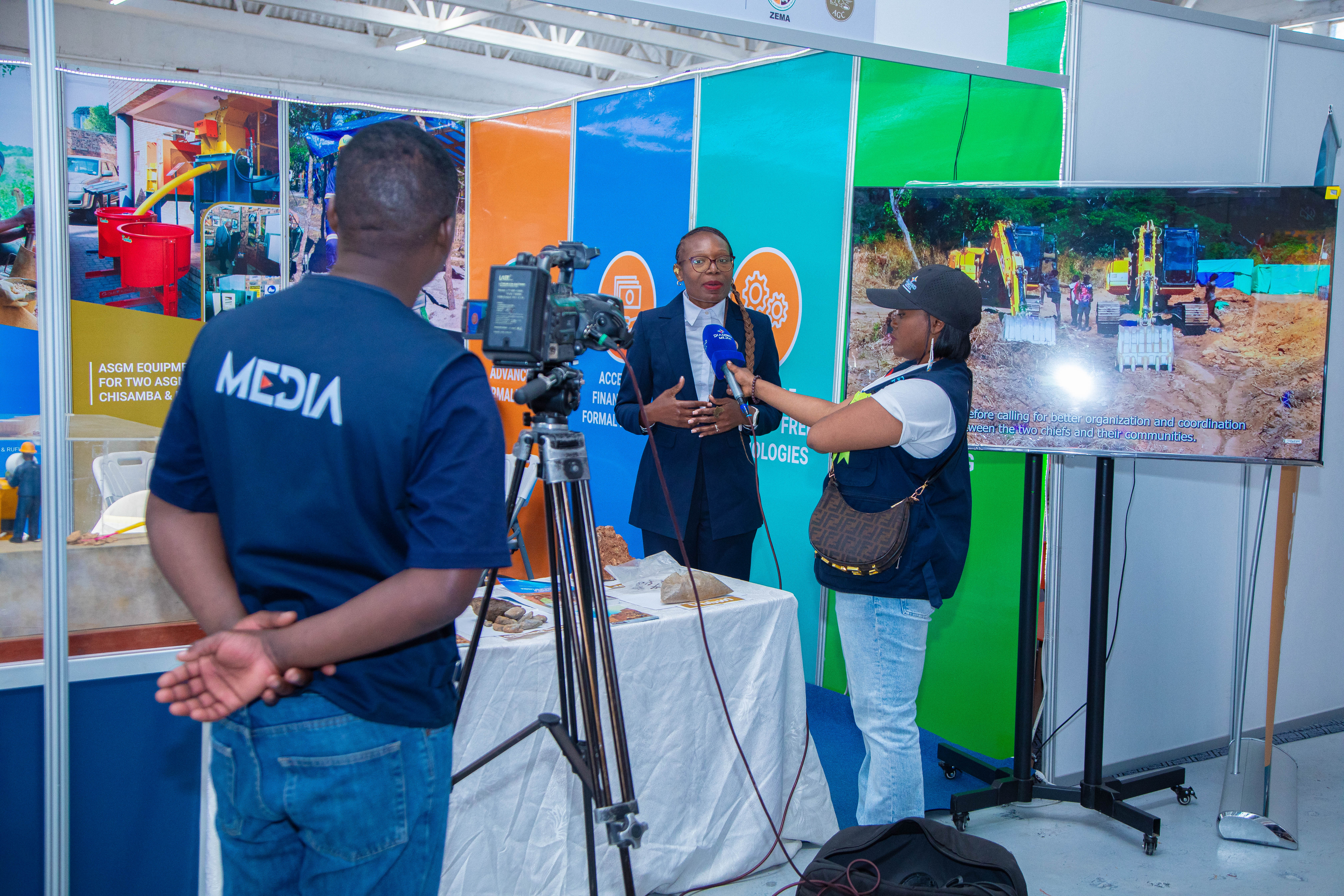 The planetGOLD Zambia National Project Manager Ms. Abigail Mwailenge Speaking during a media interview at the exhibition 