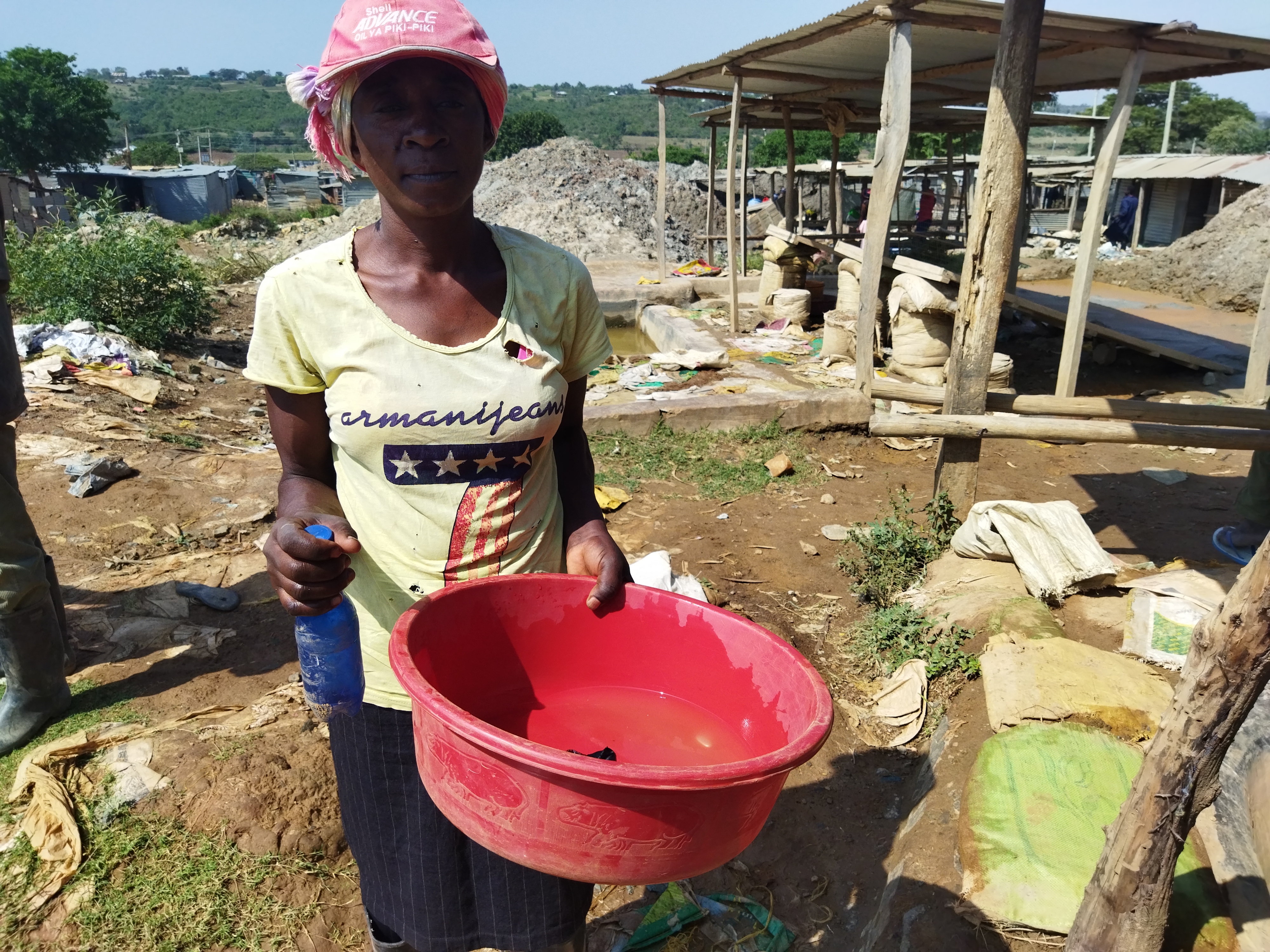 Kenyan woman miner with red bowl