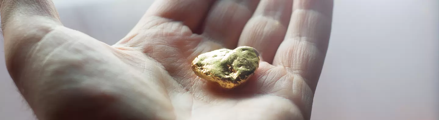 Hand holding gold nugget