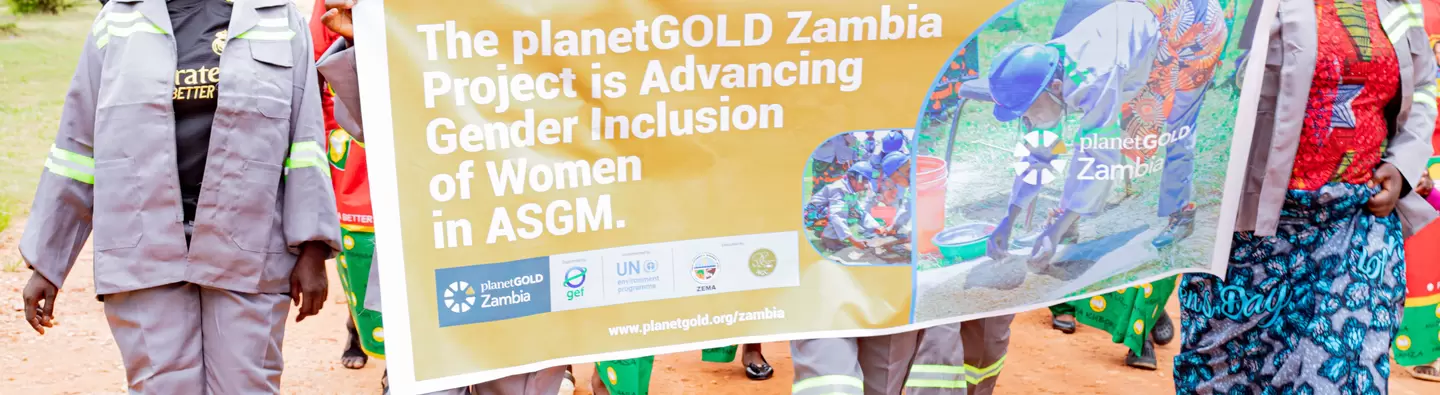 Women ASGM marching with a planetGOLD banner