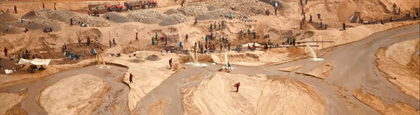a sandy landscape with people in a distance