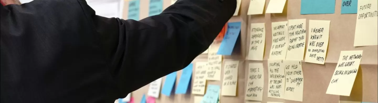 A wall board full of post-it