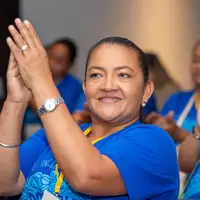 Mujer aplaude testimonio en conversatorio inclusion financiera