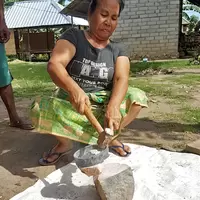 Female miner crushing ore in Sekotong, West Lombok, Indonesia