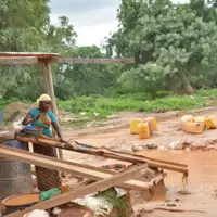 Burkina Faso woman miner working sluice