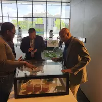 Technical officer explaining miniature model of mine circuit