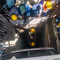 Miners descend in a pit