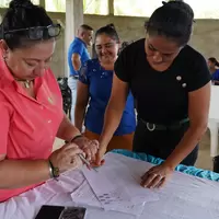 Mujer de la cooperativa firmando la personería jurídica