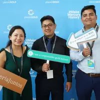 Attendees posing with signs
