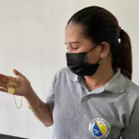 A town officer shows the winning jewelry design during the 22nd Pabirik festival by artist Glenn Valeros.