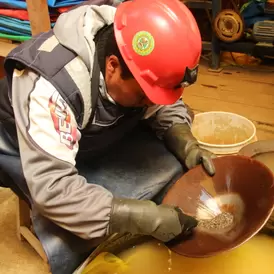 Small-scale miner in Puno, Peru panning to extract gold