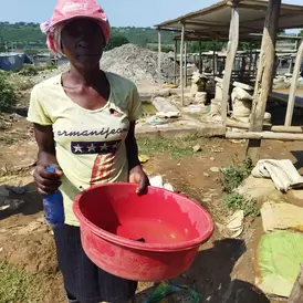 Kenyan woman miner with red bowl