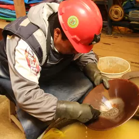 Small-scale miner in Puno, Peru panning to extract gold
