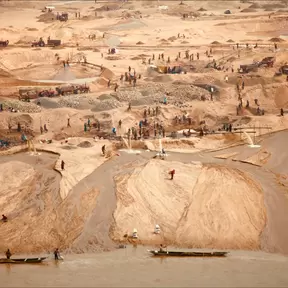 a sandy landscape with people in a distance