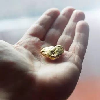 Hand holding gold nugget