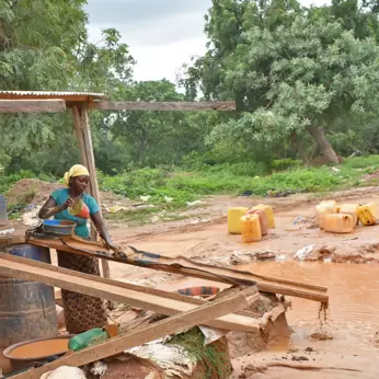 Burkina Faso woman miner working sluice