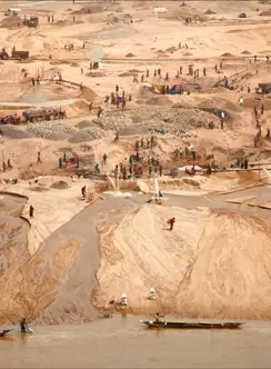 a sandy landscape with people in a distance