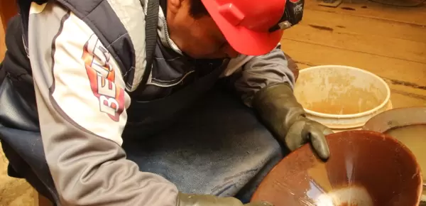Small-scale miner in Puno, Peru panning to extract gold