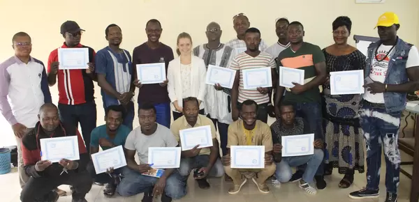 Participants holding their certificates after completing the workshop
