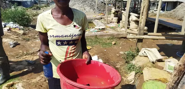 Kenyan woman miner with red bowl