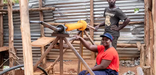 Monica demonstrates how she goes down the shaft to get her ore