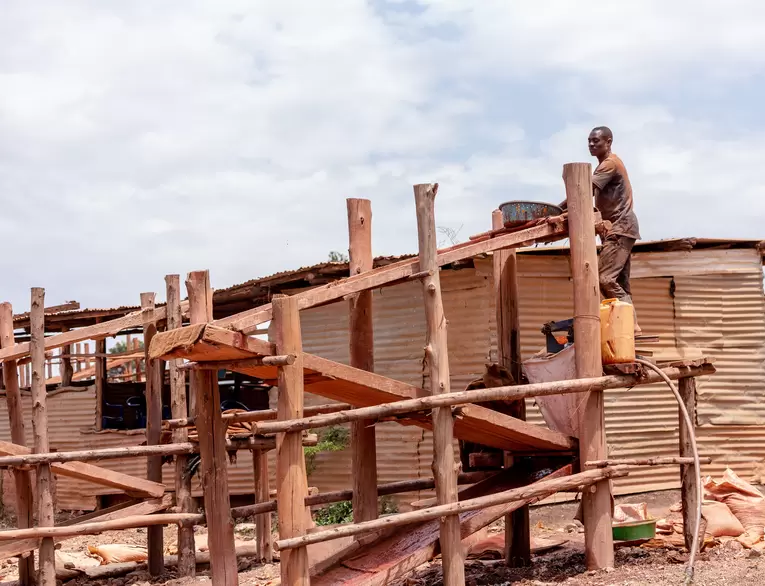 A miner uses a sluice